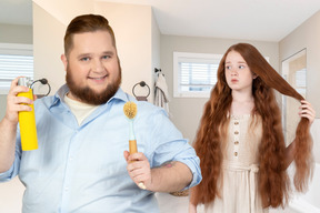 A man holding cleaner spray and brush standing next to a girl in the bathroom 
