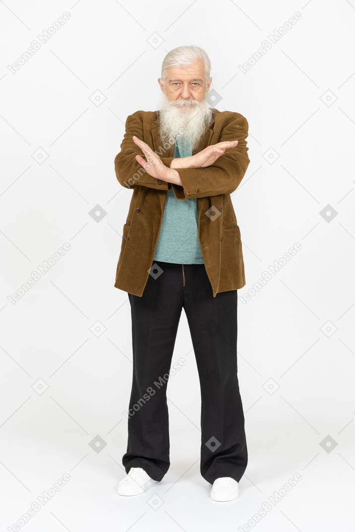 Elderly man making stop sign with his arms