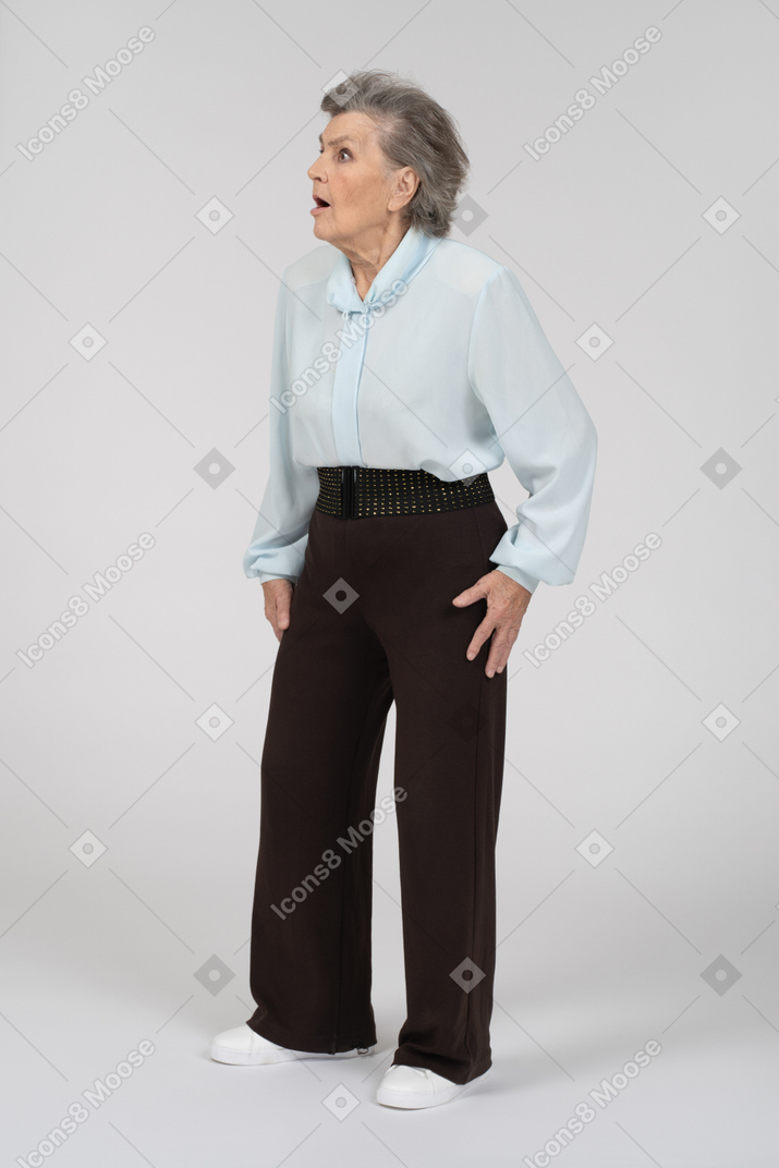 Three-quarter view of an old woman looking lost