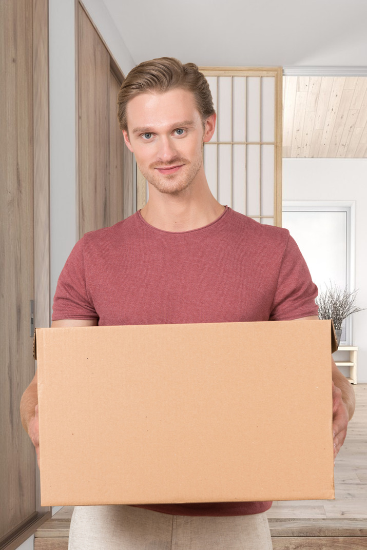 A man holding a cardboard box in his hands