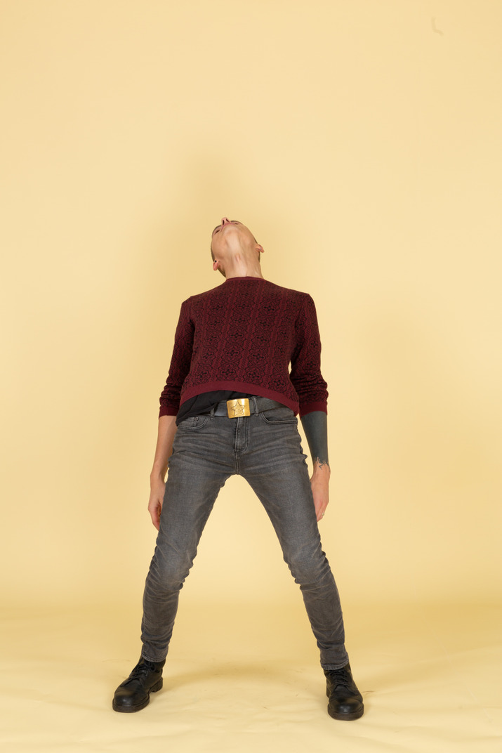 Back view of a young man in red pullover leaning back