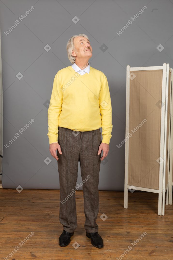 Front view of a curious old man looking up