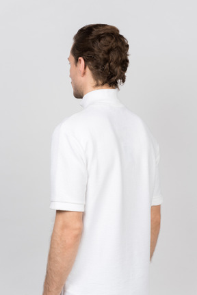 Back view of young man in white polo t-shirt