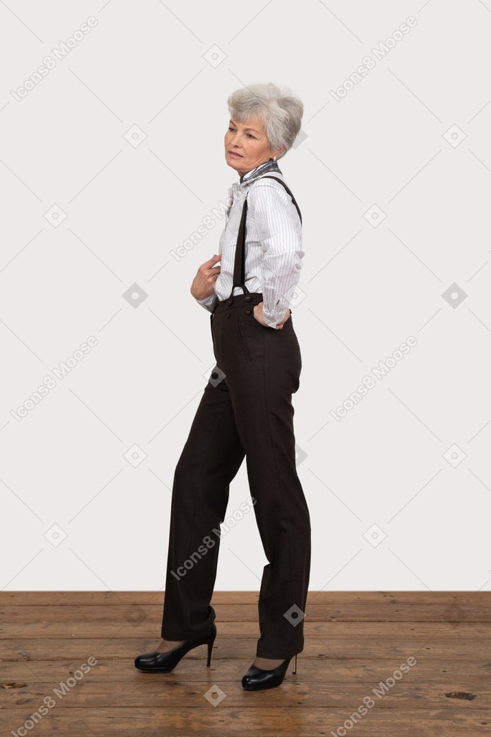 Side view of an egoistic old female pointing at herself