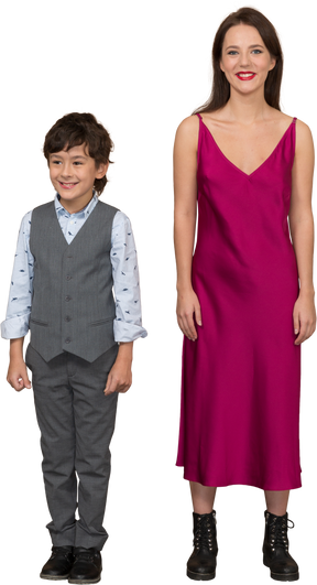 Woman in red dress standing with smiling boy