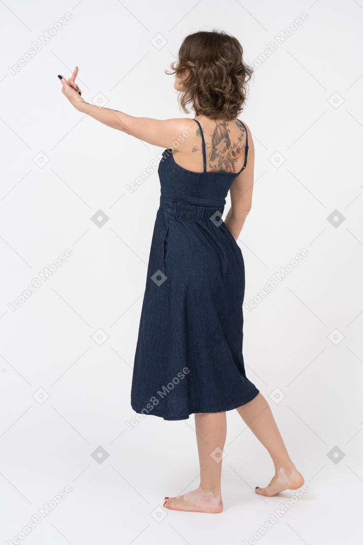 Tattooed girl making a rude gesture sideways