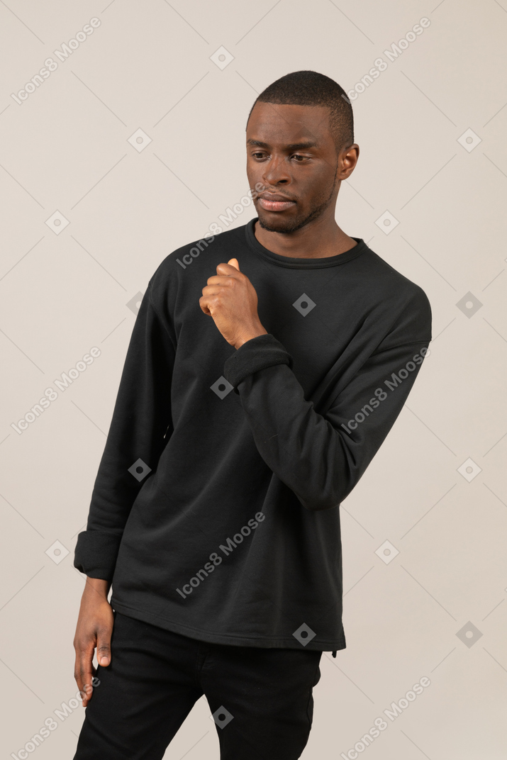 Pensive young man in black outfit