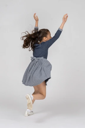 Three-quarter back view of a girl running and dashing around