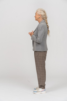 Old lady in suit standing in profile