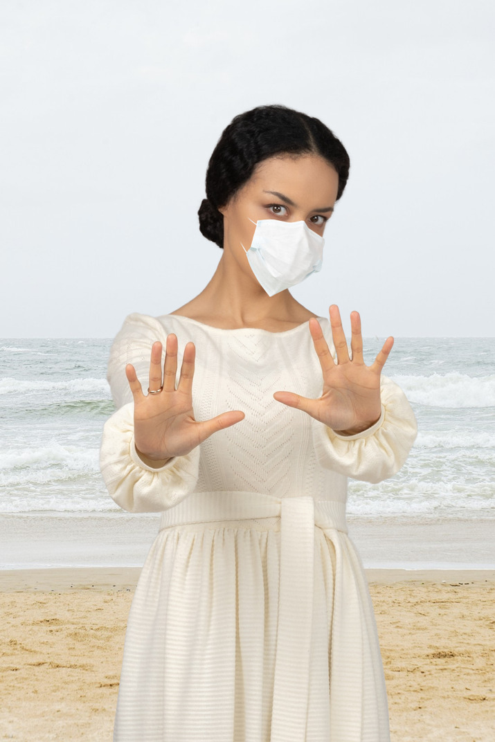 Woman wearing a face mask and keeping distance