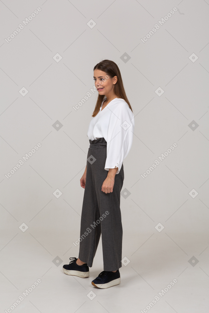 Three-quarter view of an arrogant young lady in office clothing