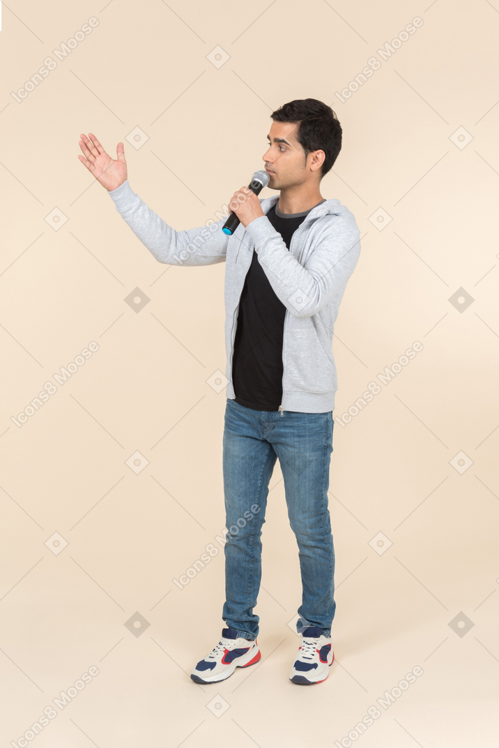 Young caucasian man speaking into a microphone
