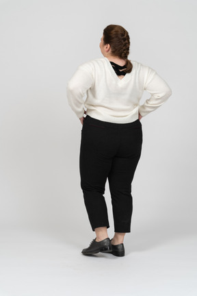 Plus size woman in casual clothes standing with hands on hips