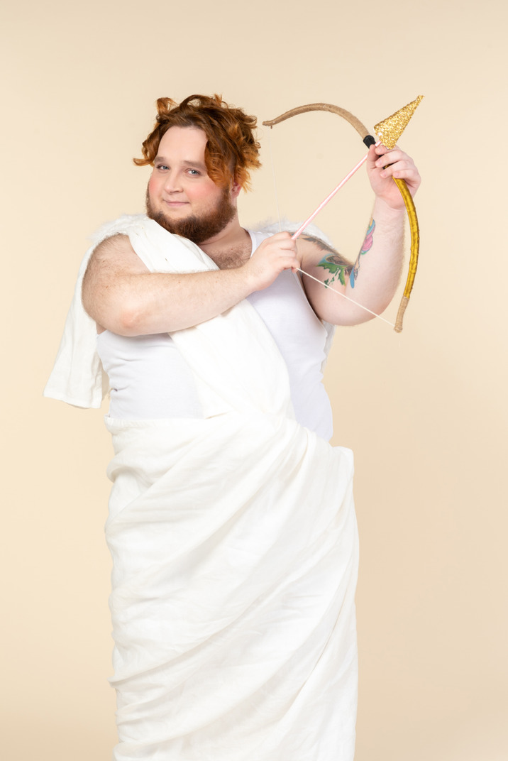 Big guy dressed as a cupid holding bow and arrow