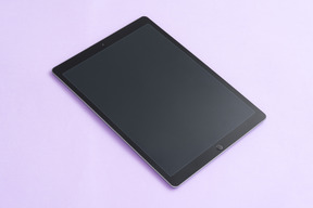 Digital tablet over lilac background