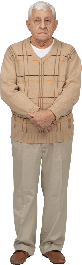 Front view of an old man in casual clothes looking at camera