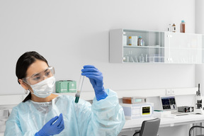 A woman in a lab holding a test tube