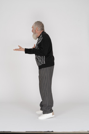 Elderly man outstretching his arm