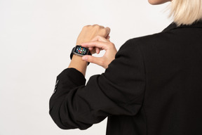 A cropped shot of a young woman wearing smartwatch