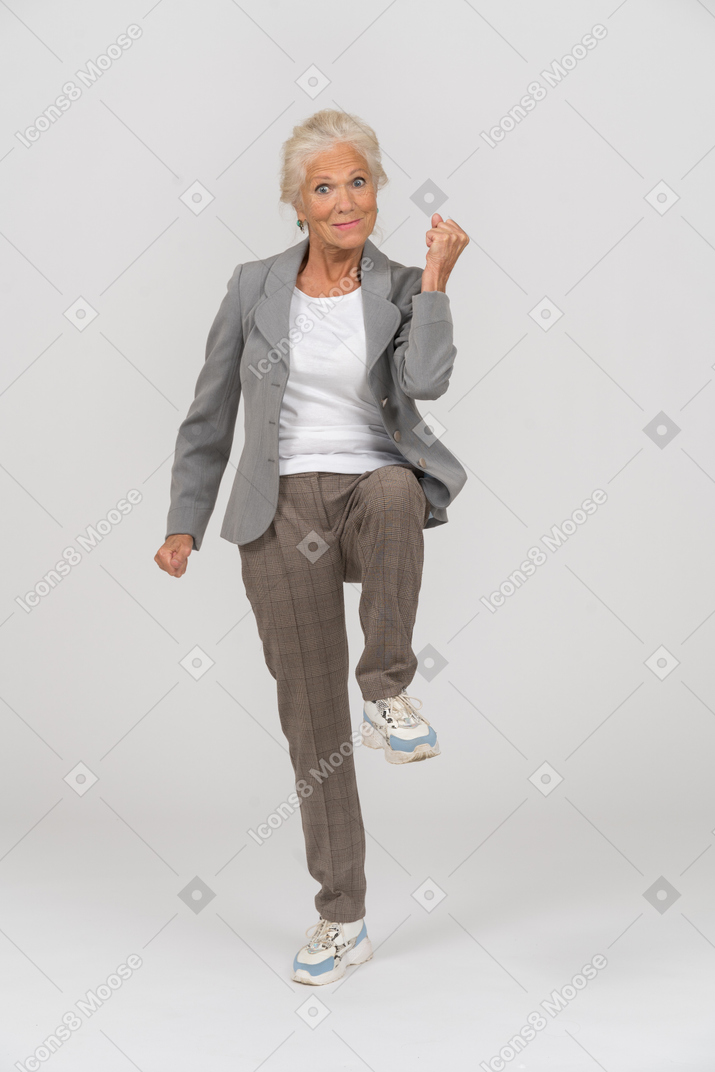Front view of a happy old lady marching