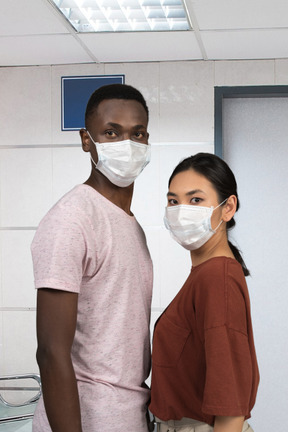 A man and a woman wearing face masks