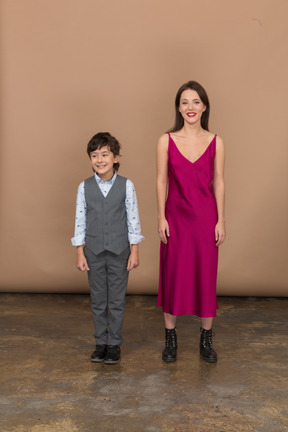 Boy standing with woman