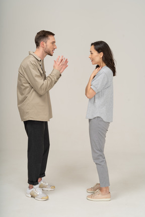 Side view of young couple speaking to each other