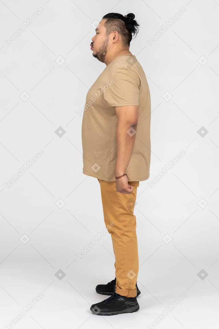 Young man standing sideways