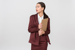 Attractive formally dressed woman holding a clipboard