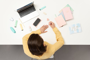 A female office worker doing her nails at the table