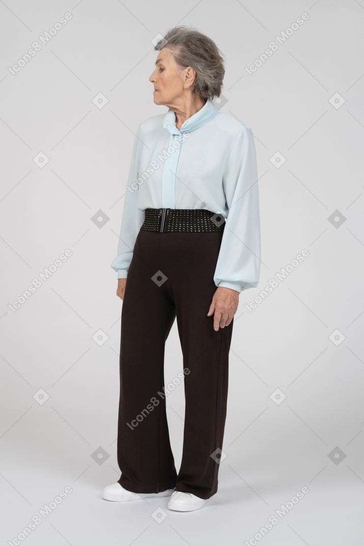 Old woman standing and looking away