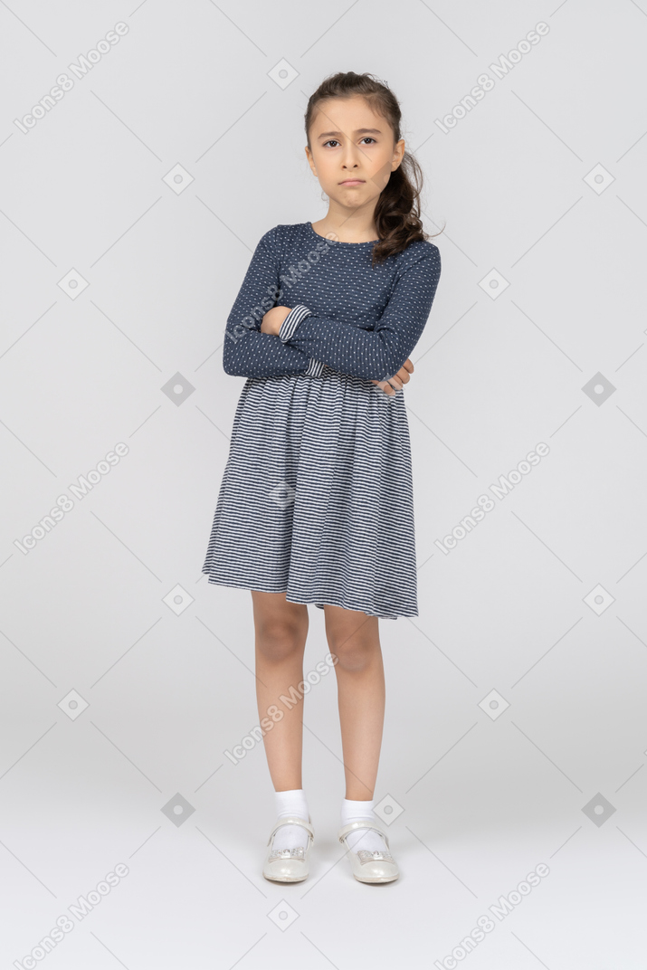 Front view of a girl pouting with hands folded