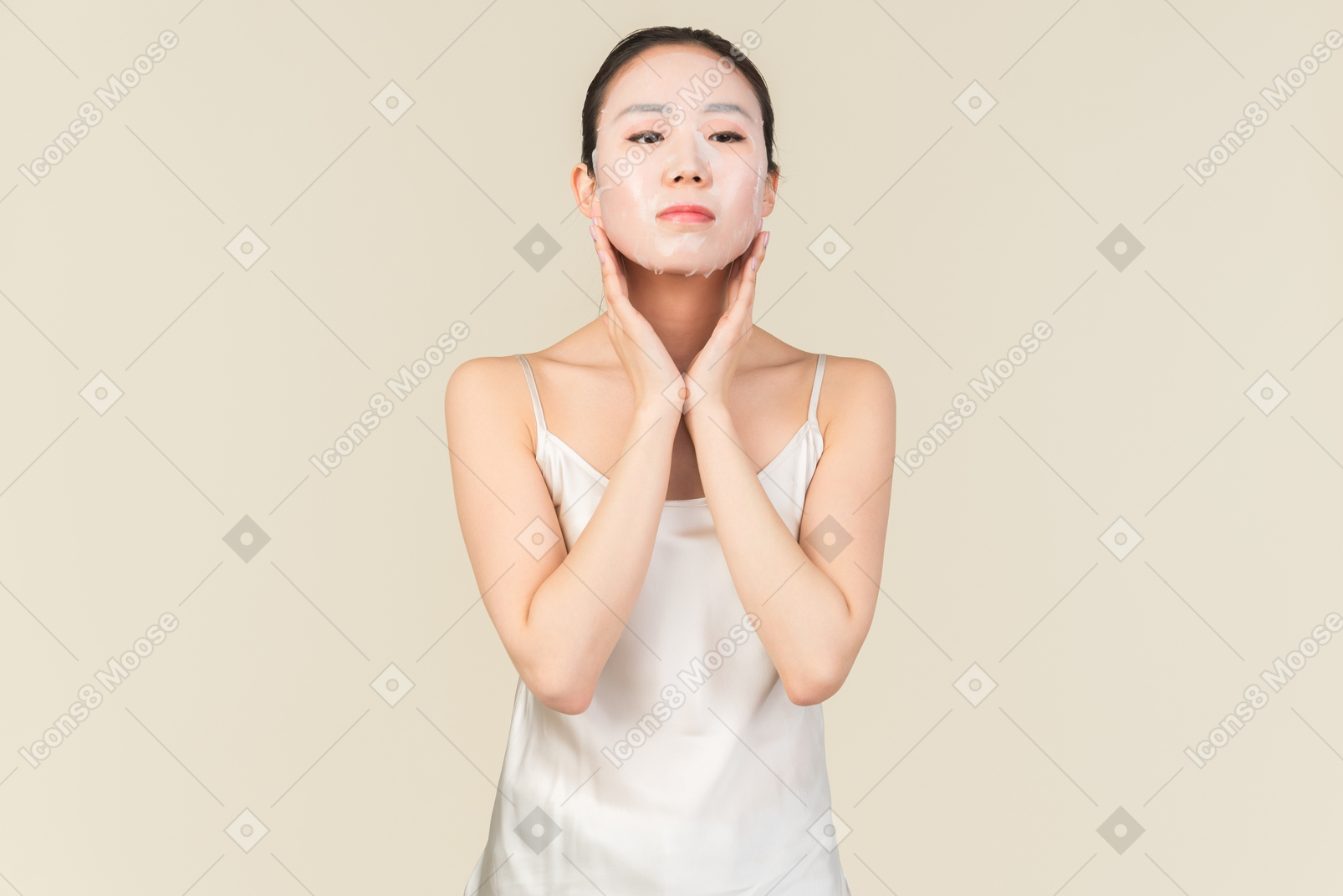 Young asian woman applying face mask on her face