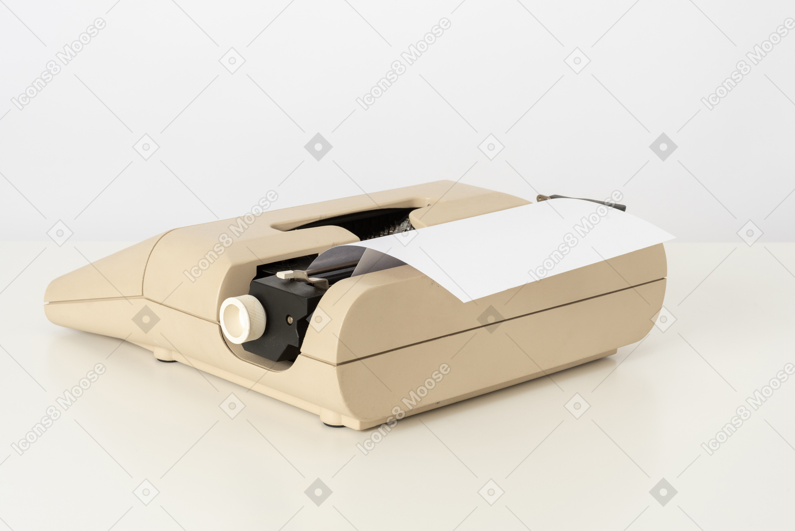 Beige typewriter on a white background