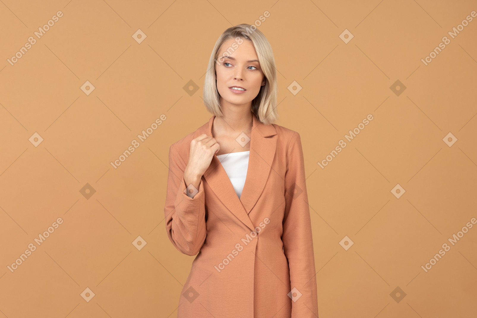 Pensive young woman in terracotta jacket