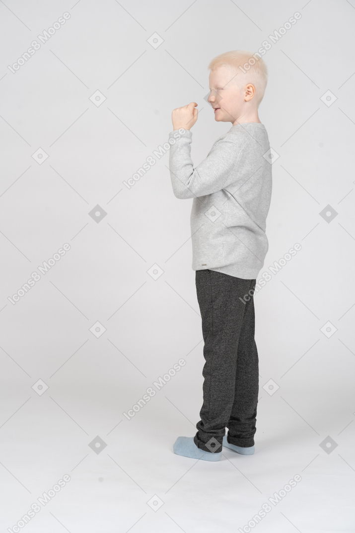 Little boy gesturing and saying something
