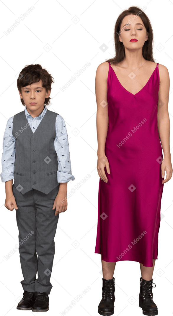 Woman in red dress with closed eyes standing still with boy