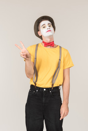 Male clown showing peace signs