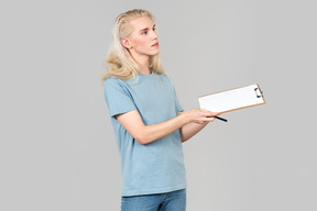 Young activist guy standing half sideways and holding folder