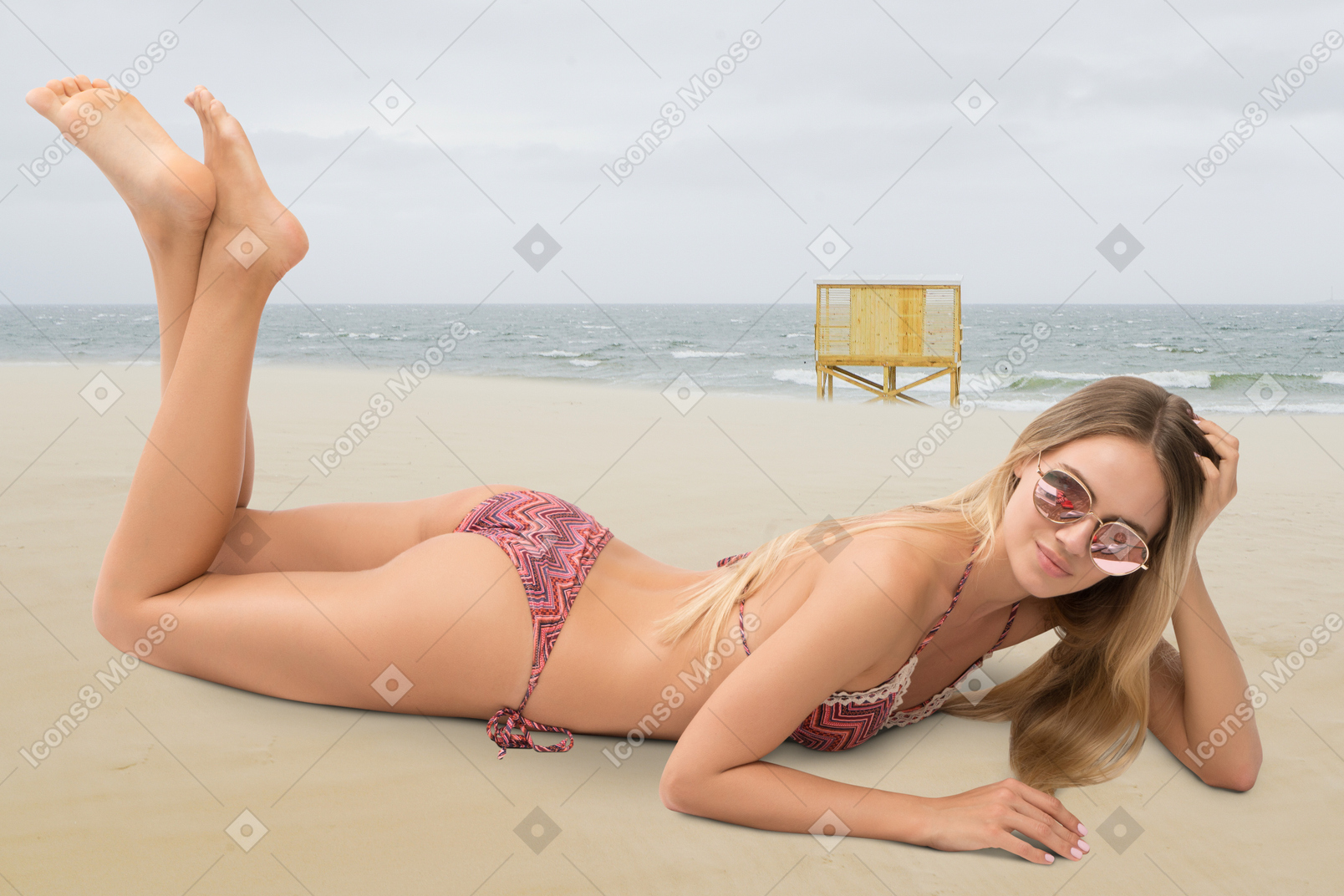 A woman in a bikini lying on the beach