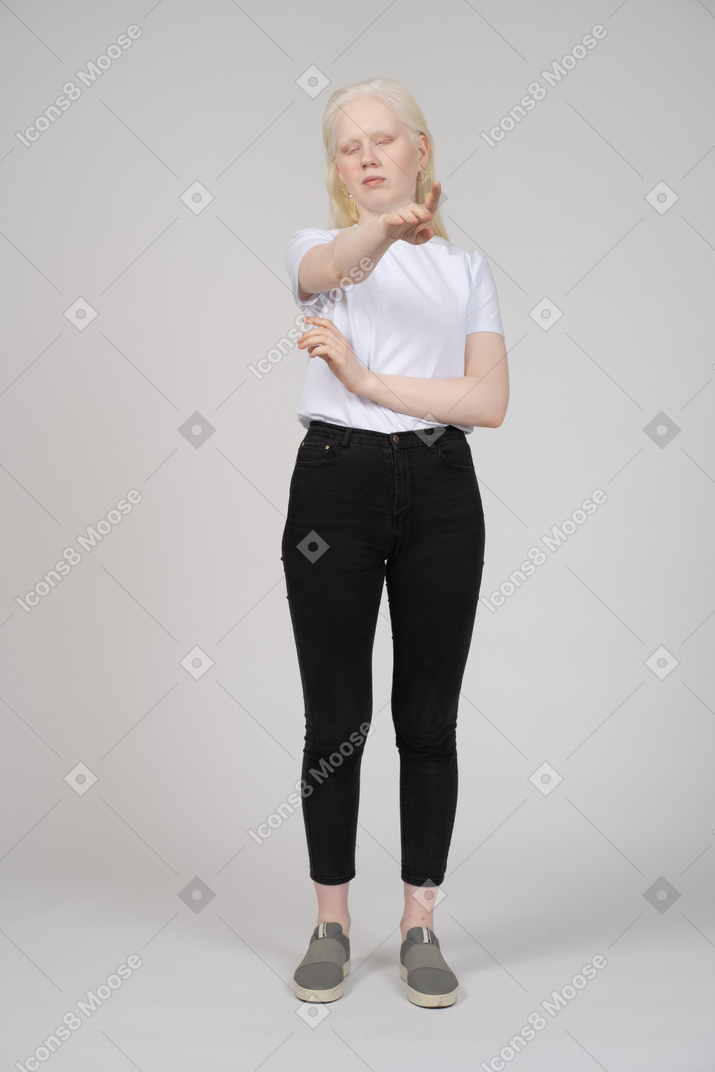 Woman in casual clothes pointing upwards