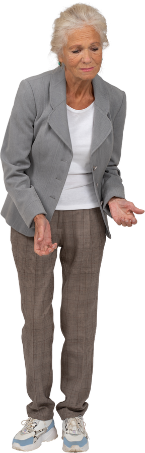 Front view of a sad old lady in suit bending down