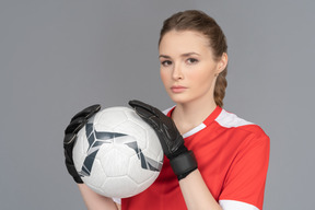 Eine schöne sportliche frau, die einen ball hält