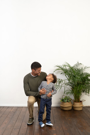 Good looking young man on knees with a boy