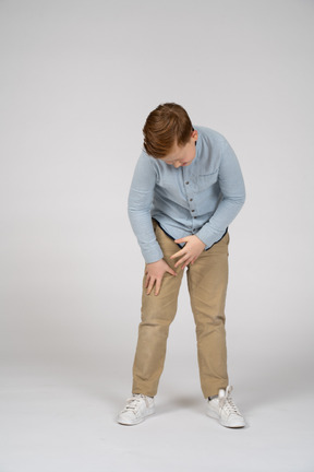 Front view of a boy bending down