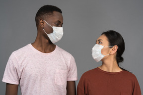 A young couple wearing face masks