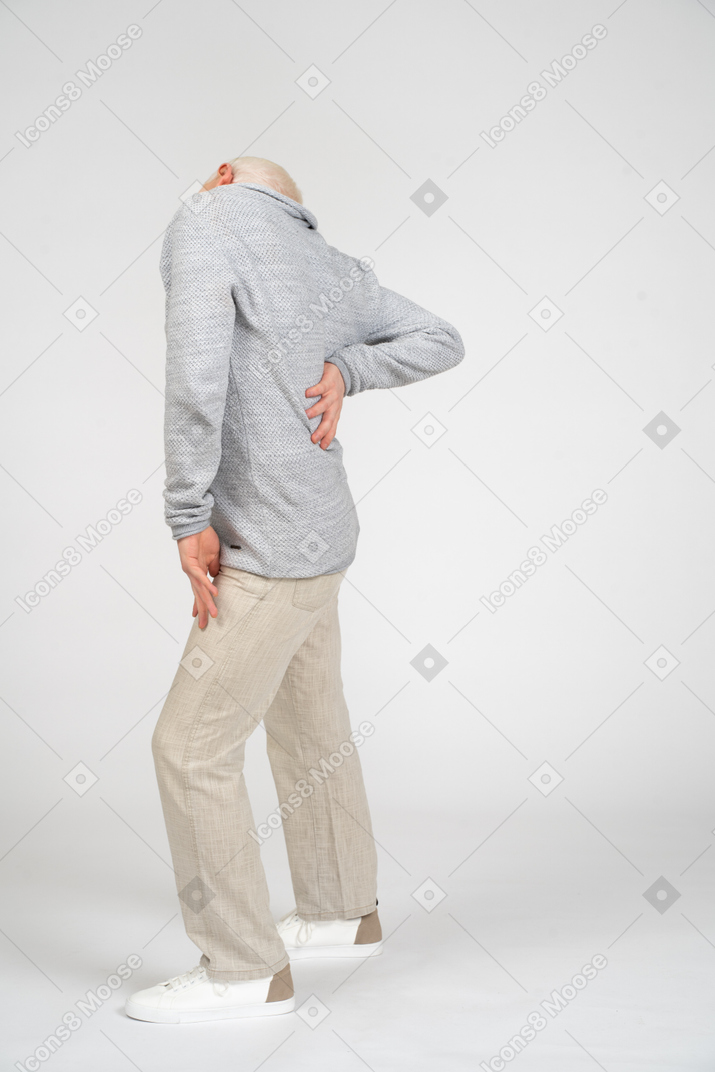 Side view of middle-aged man suffering from lower back pain
