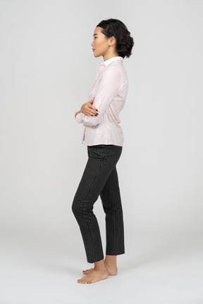 Side view of a woman in office clothes with arms crossed