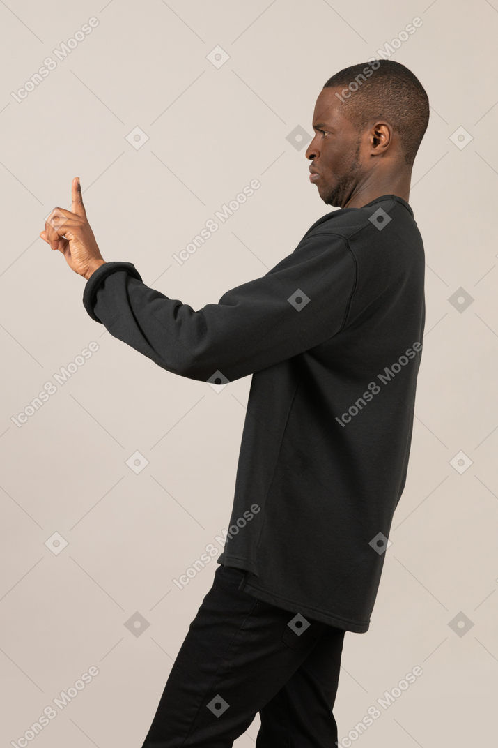 Side view of man asking to stop with finger