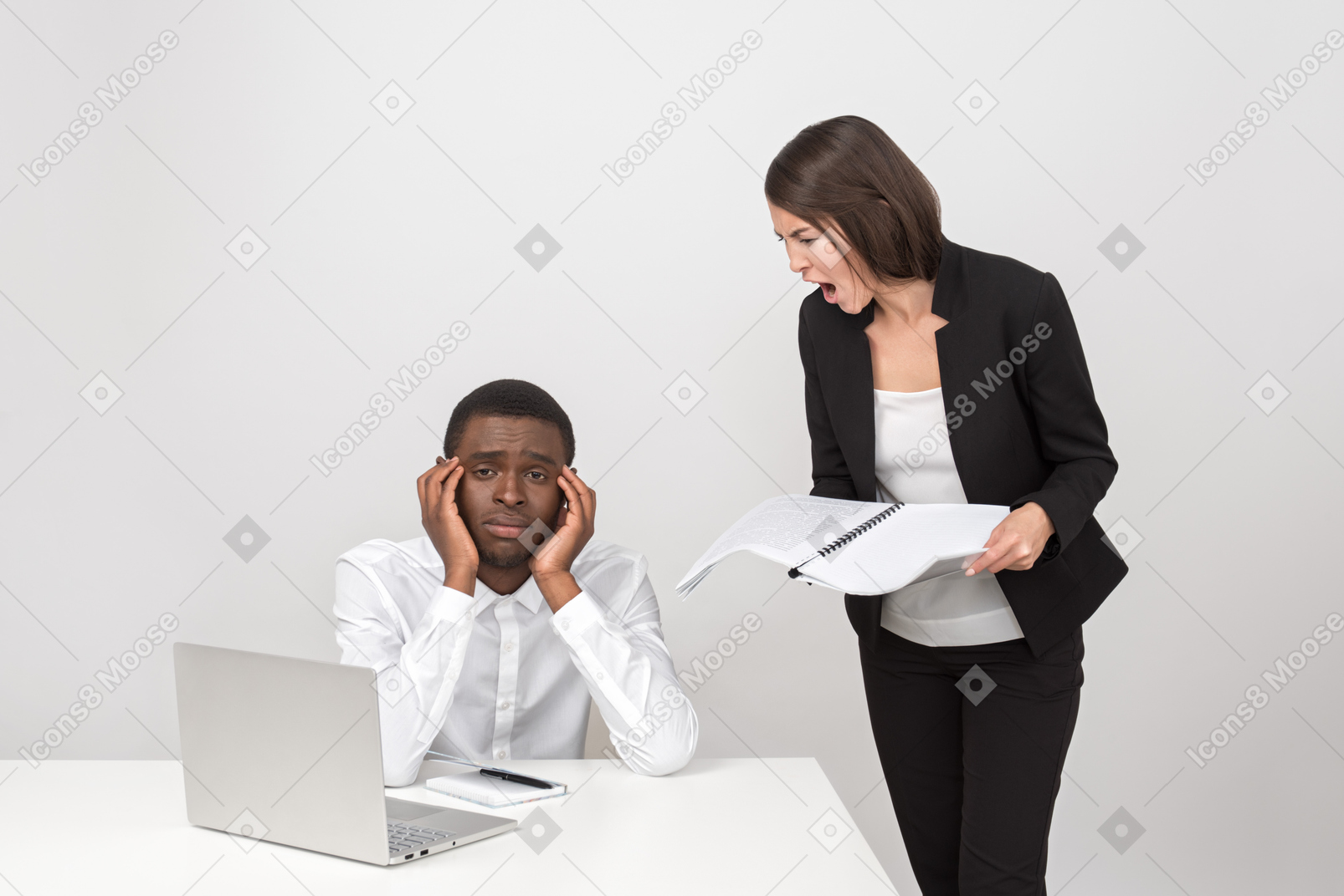 Angry female boss shouting at her upset employee